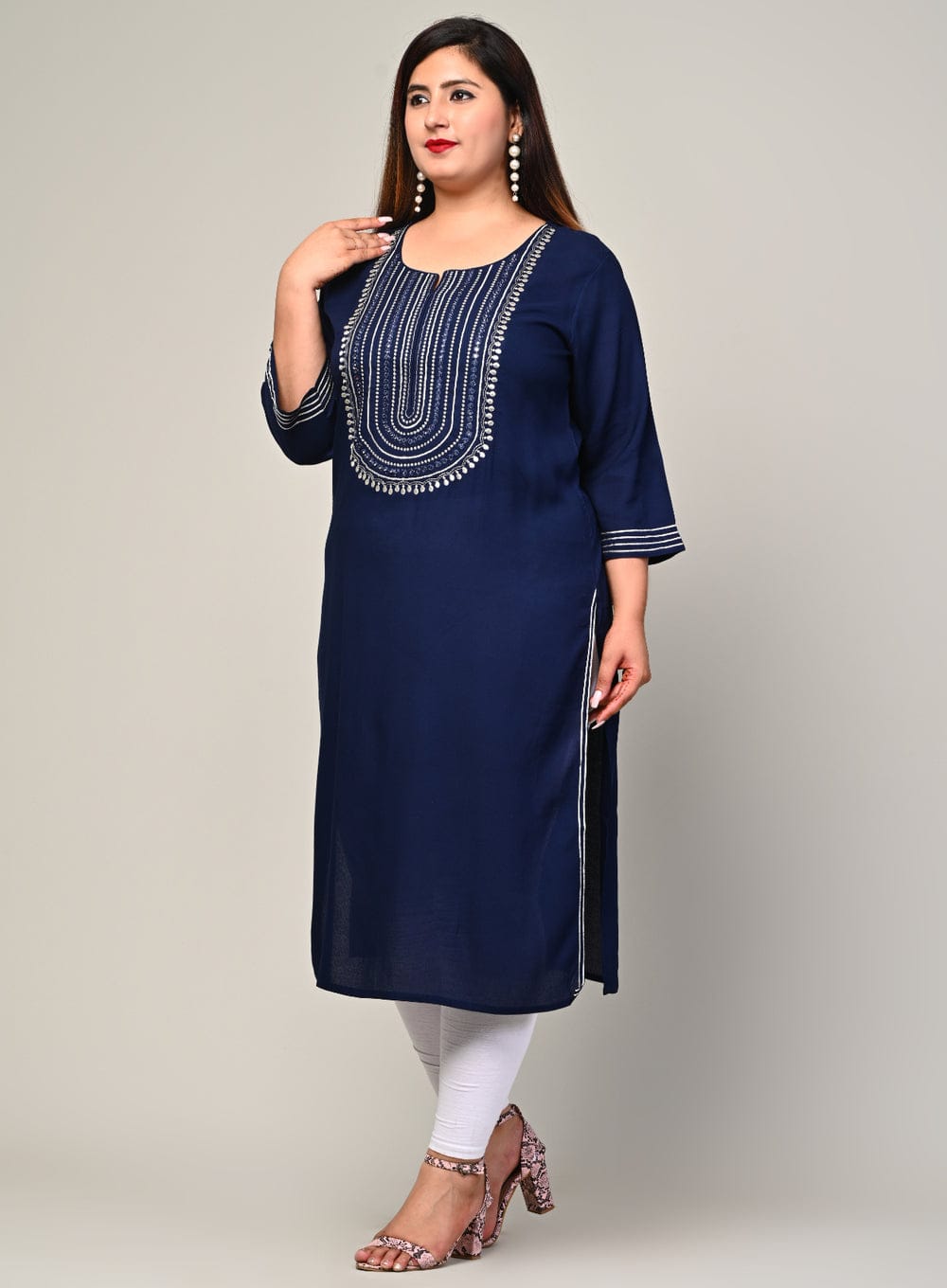 Confident stance front view of navy rayon kurti with mirror work, breathable fabric for full figure comfort