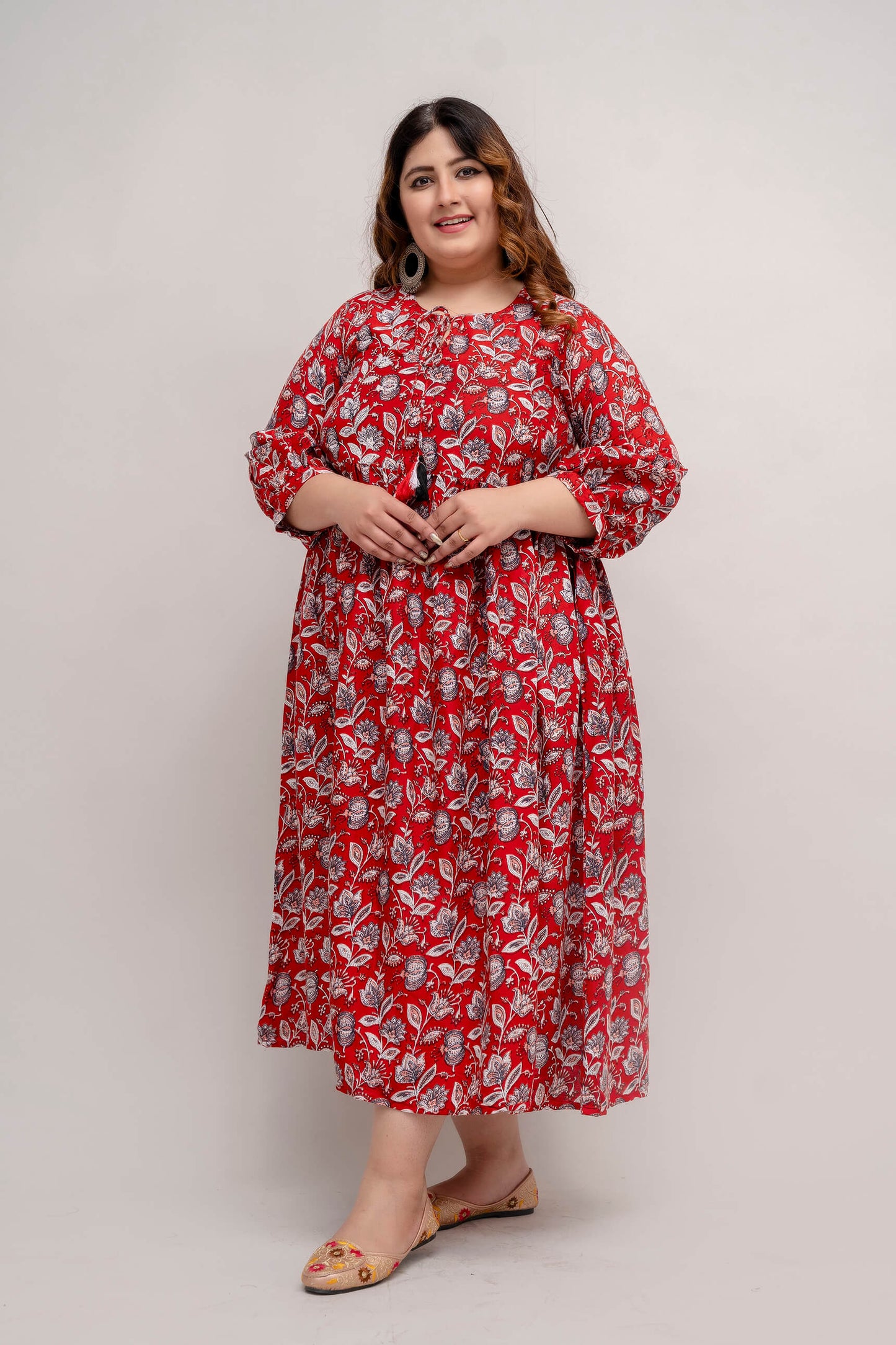 Stylish front pose of curvy model wearing red rayon gathered dress fat friendly fit