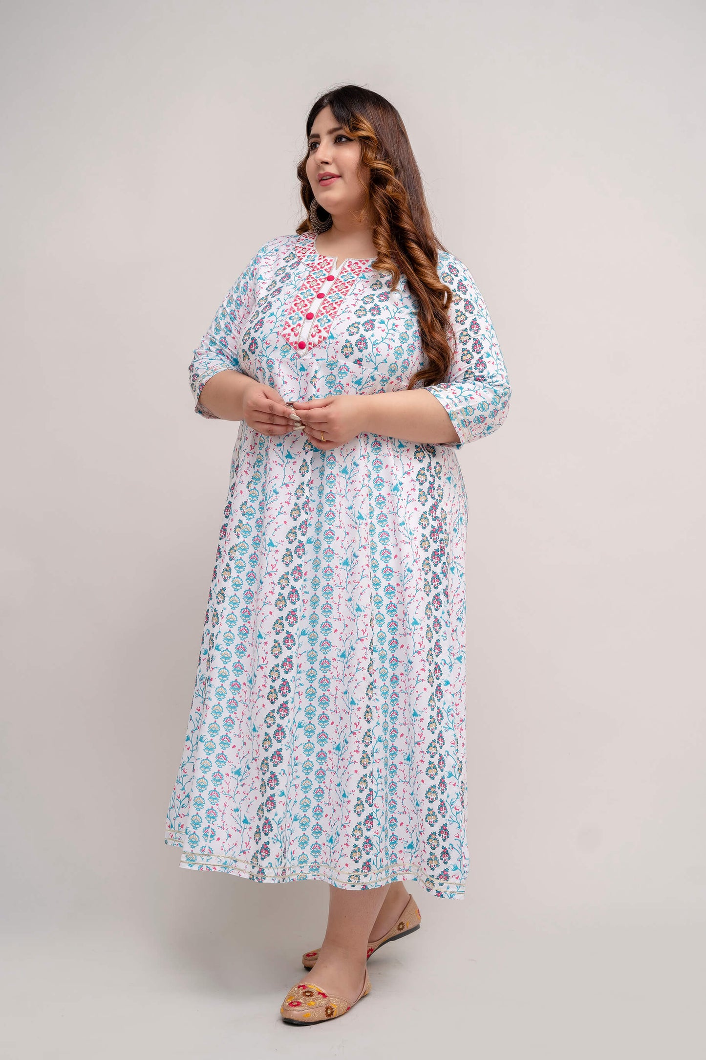 Side pose of plus size white turquoise rayon gown with soft flare