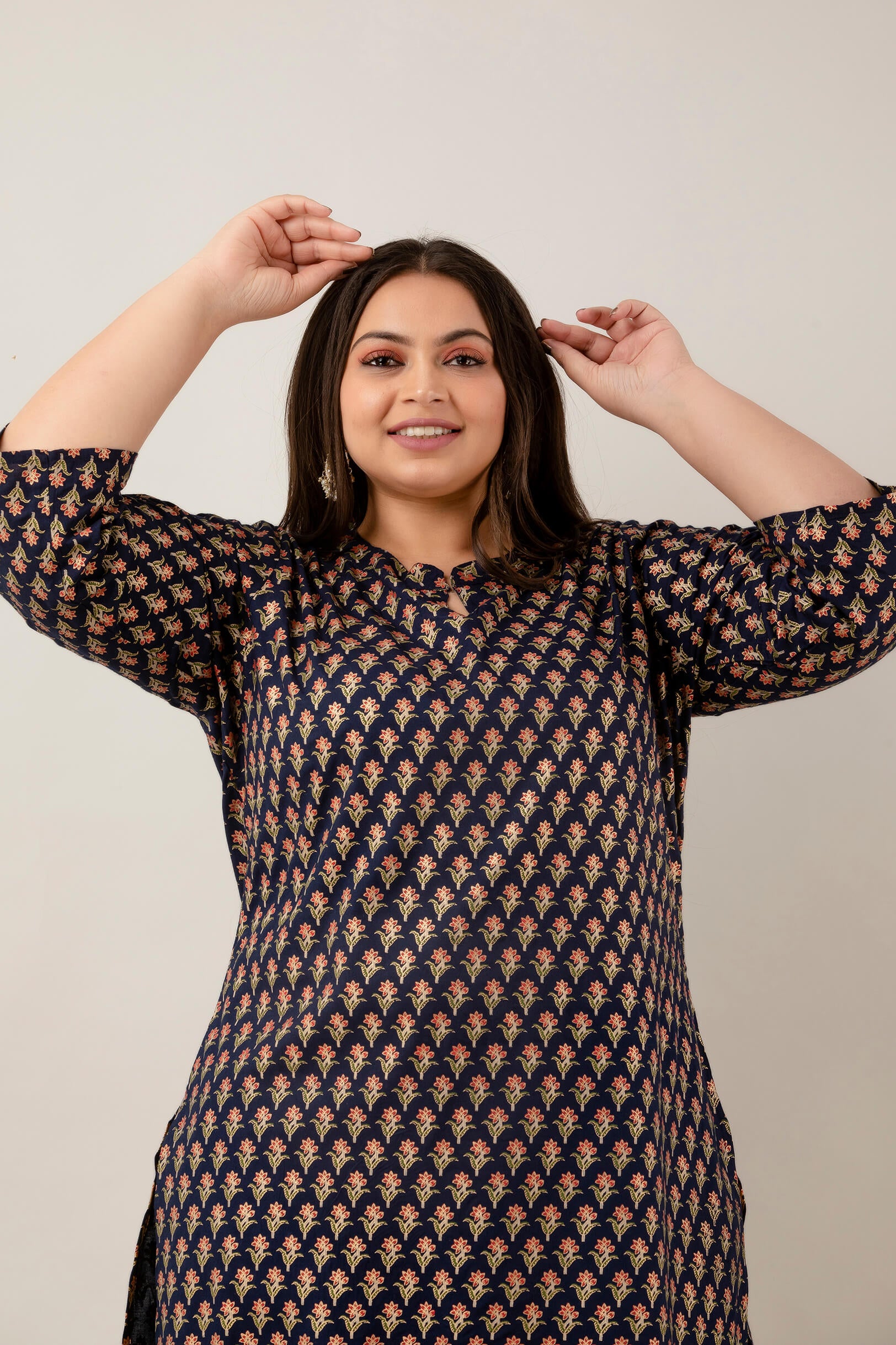 Closeup of floral buta print on navy rayon; lightweight, breathable fabric; chic ethnic pattern for big-size shoppers.