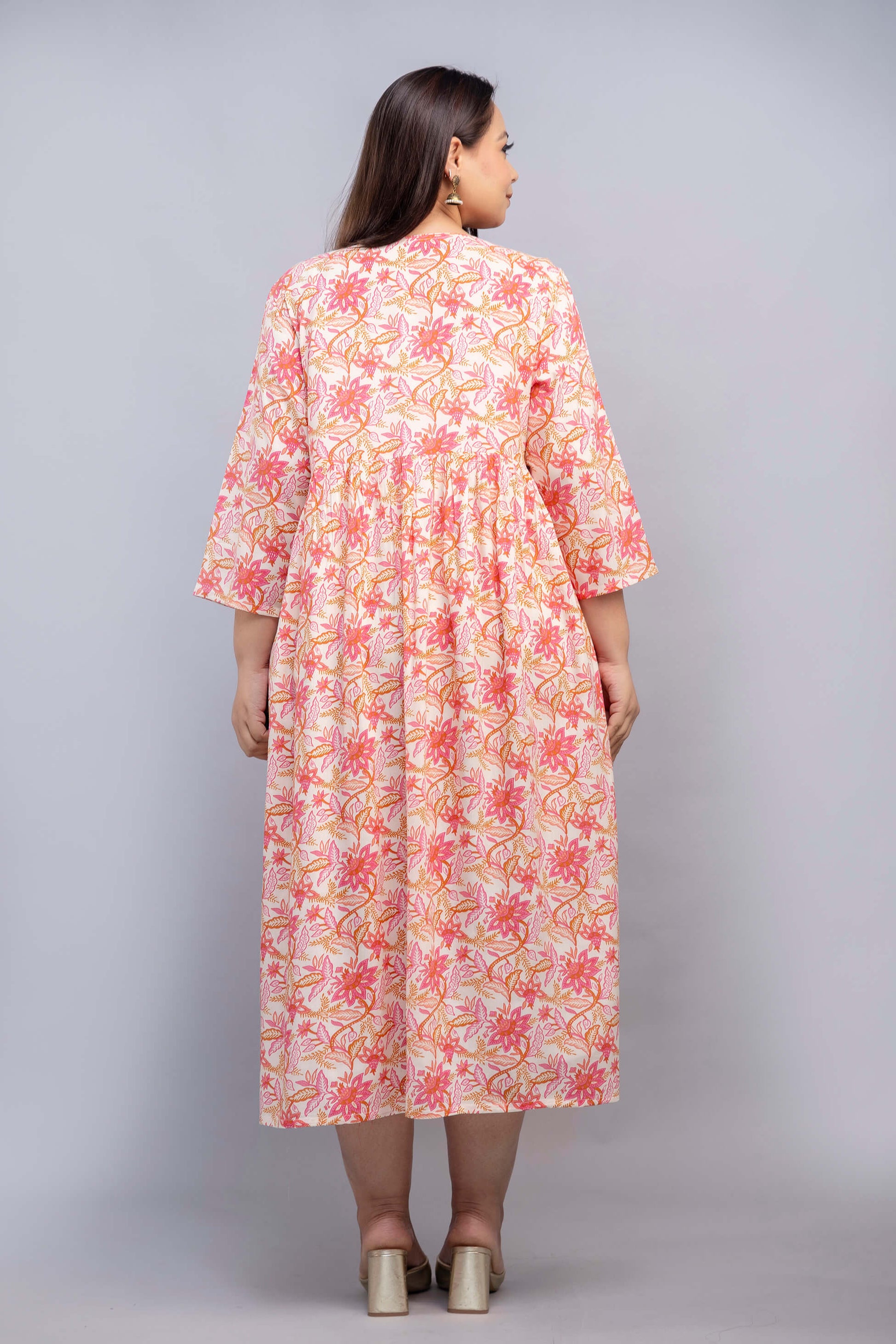 Back view of plus size peach pink floral rayon gathered gown for curvy women