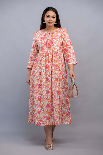 Full length pose of peach pink floral plus size rayon gathered gown for curvy women