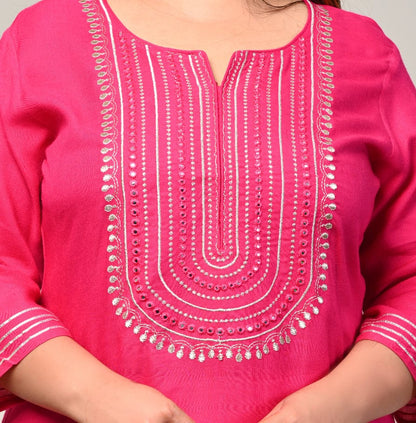 Close up of concentric mirror work yoke and notch neckline on pink rayon kurti