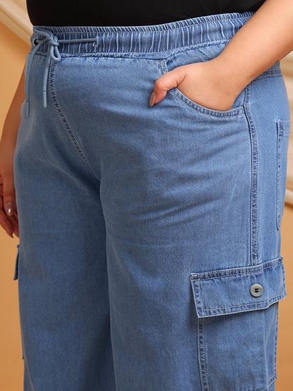 Close-up of blue denim cargo pants showing drawstring waist and pocket detail – Curvisha