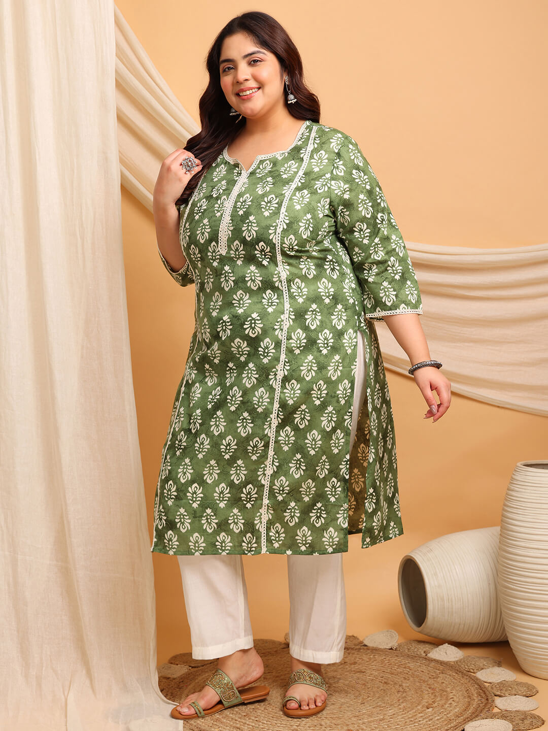 Angled front of Plus Size Green Cotton Kurti with side slit and lace panels, flattering for curves, fat friendly big size