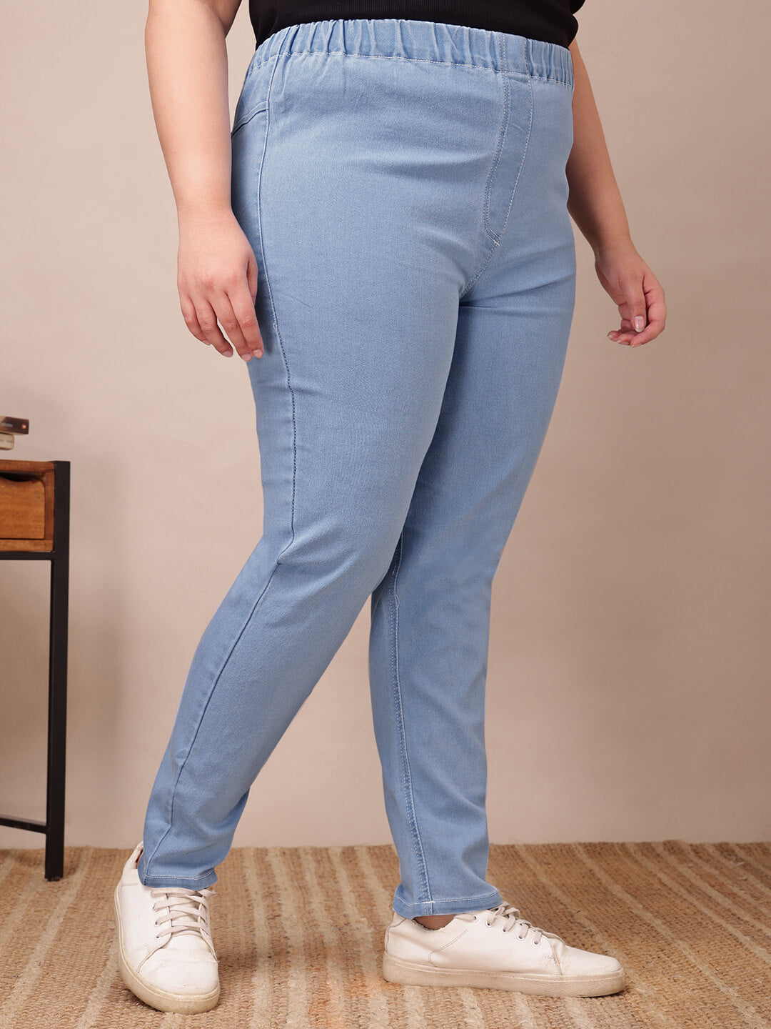 Side view of plus size light blue denim jeggings showing stretch fabric and ankle length – Curvisha