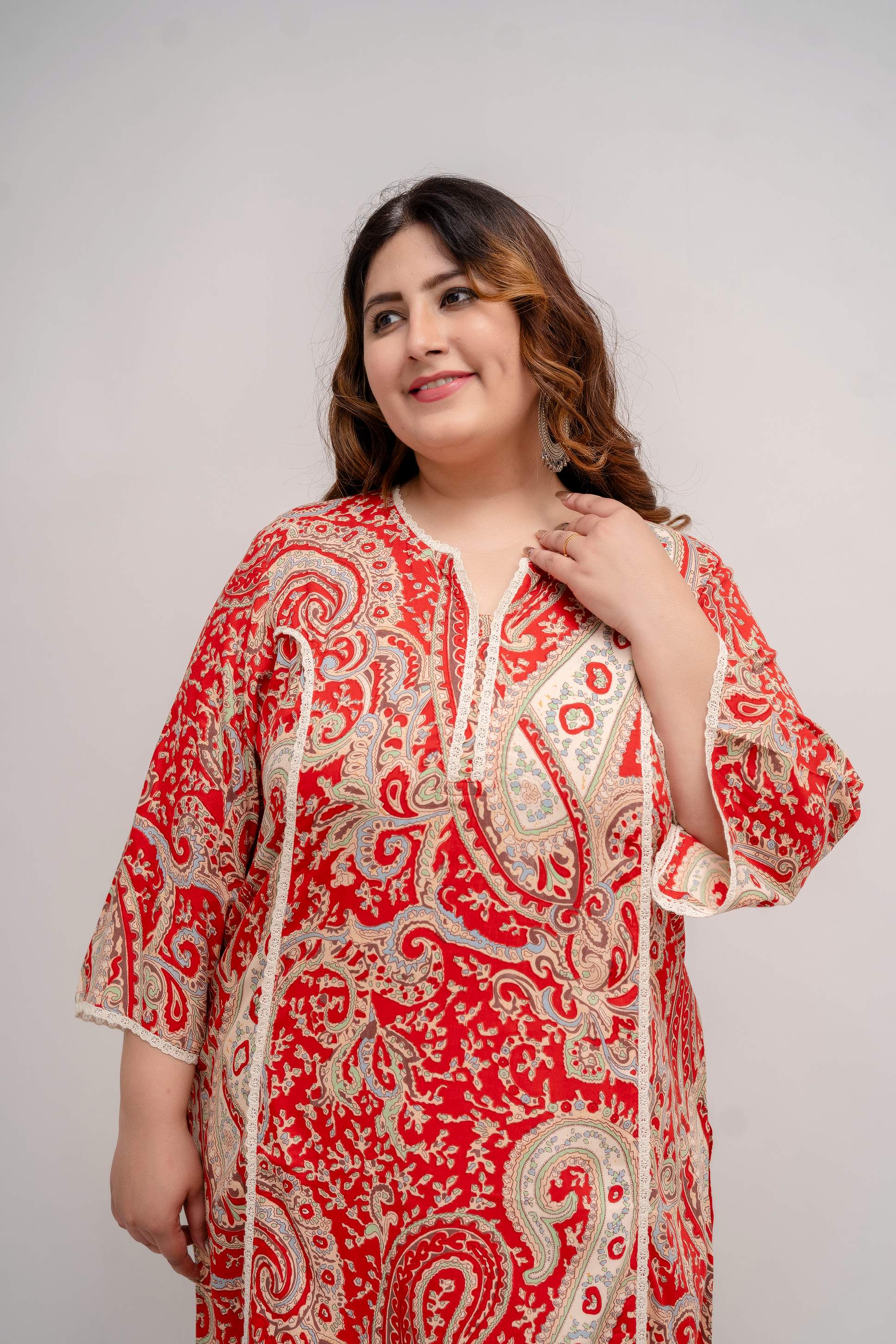 Portrait close view of red paisley rayon kurti with lace-trim notch neck, flattering on fat and curvy figures