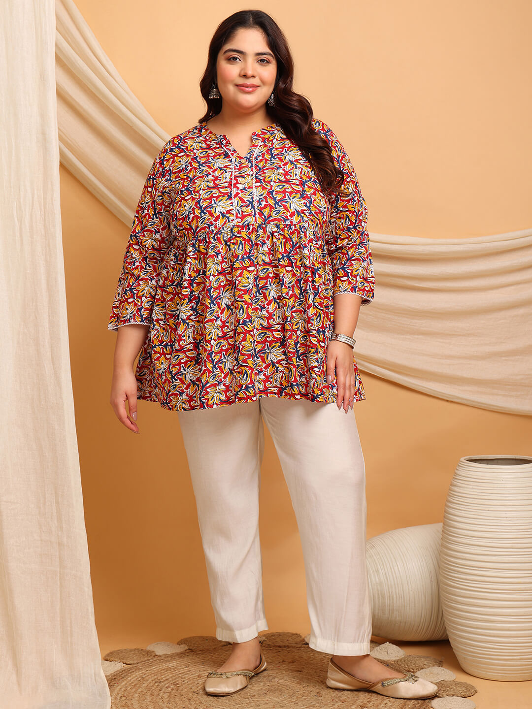 Curvy Woman Wearing Plus Size Red Floral Rayon Short Kurti with White Pants