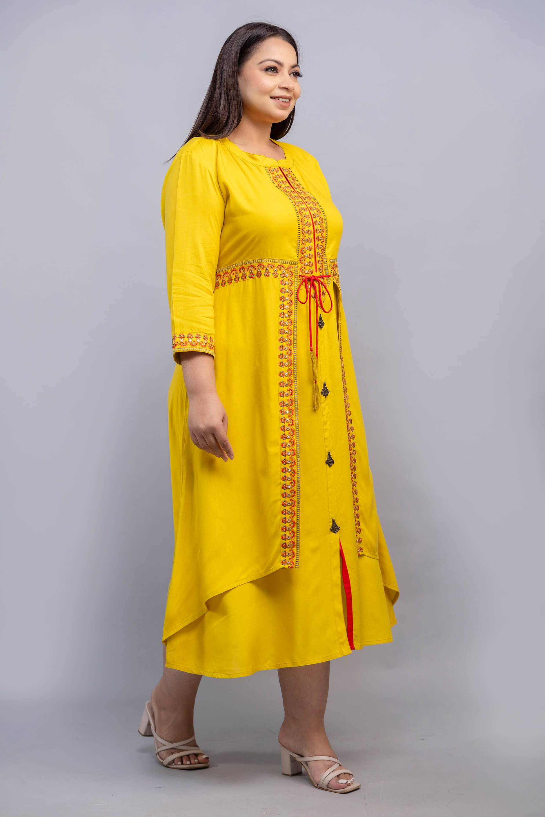 Side pose of bright yellow embroidered rayon gown for big size women