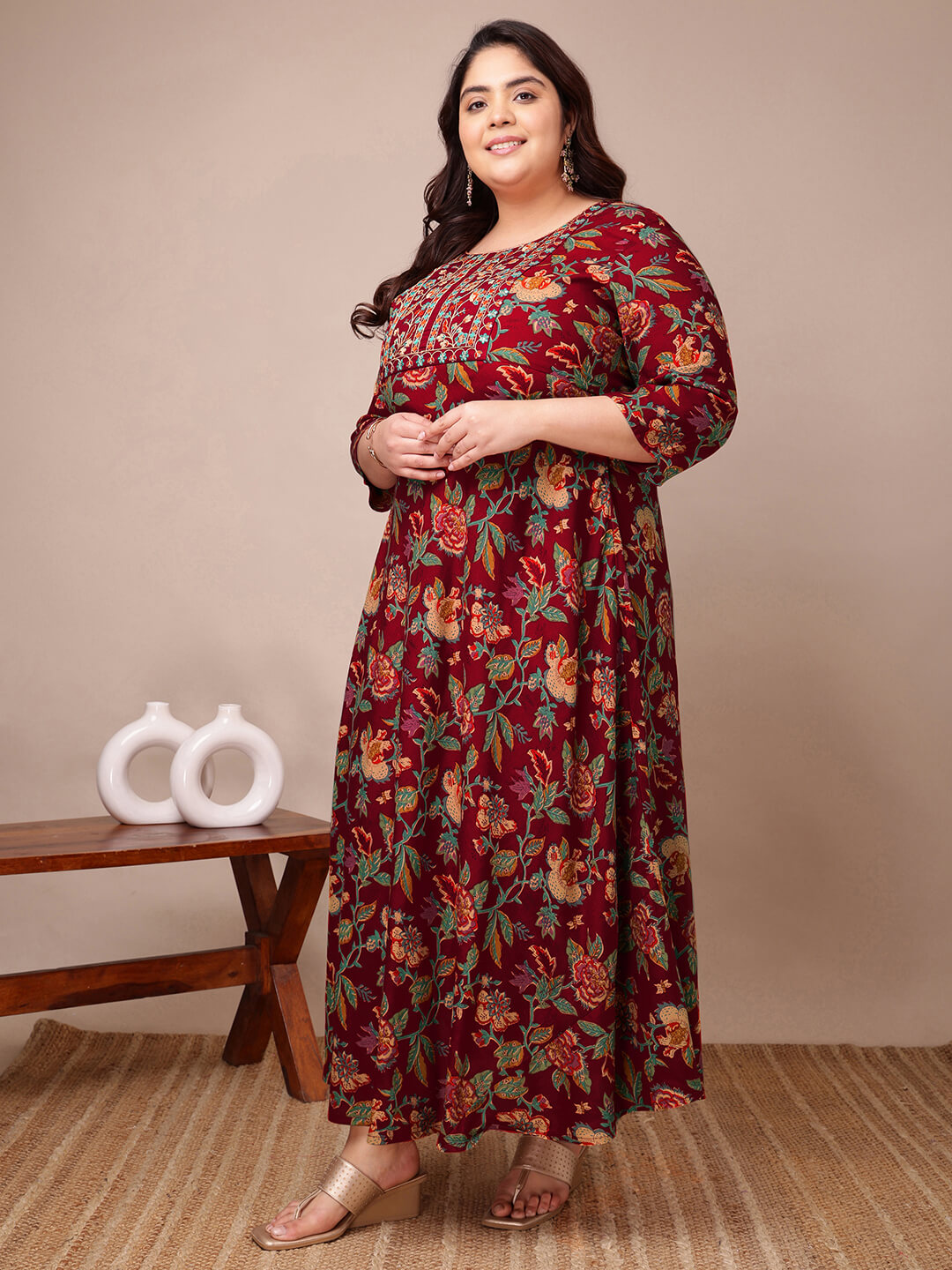 Side pose of maroon floral rayon gown dress for curvy women