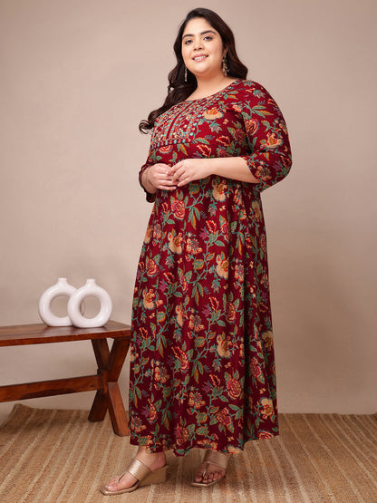 Side pose of maroon floral rayon gown dress for curvy women