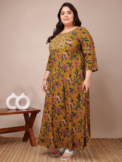 Side angle showing mustard embroidered floral gown full flare
