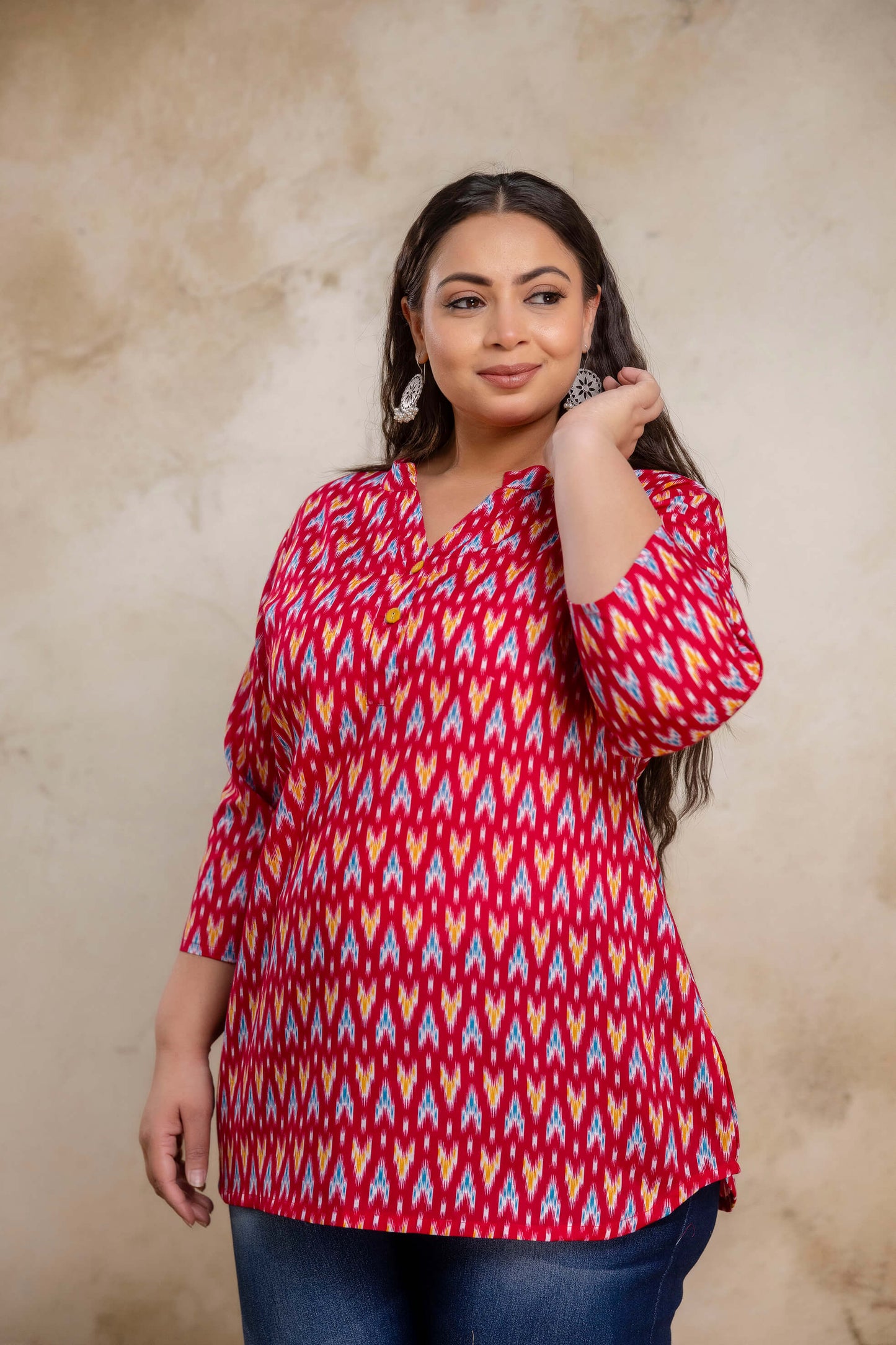 Side pose of plus size red ikat cotton short kurti tunic for daily wear