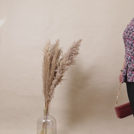 Plus size model wearing classic black wide-leg palazzo pants with a comfortable elastic waistband and side pockets.