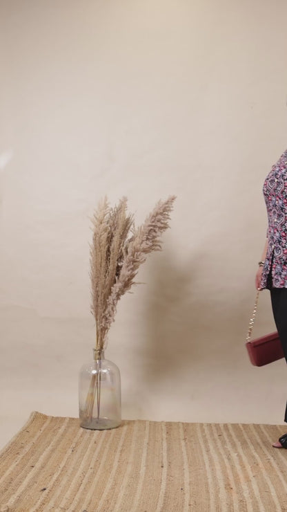 Plus size model wearing classic black wide-leg palazzo pants with a comfortable elastic waistband and side pockets.