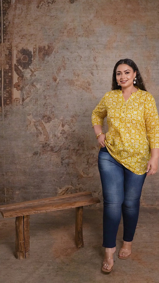 Curvisha plus size yellow short kurti with geometric print, styled with blue denim for a modern curvy fusion look.