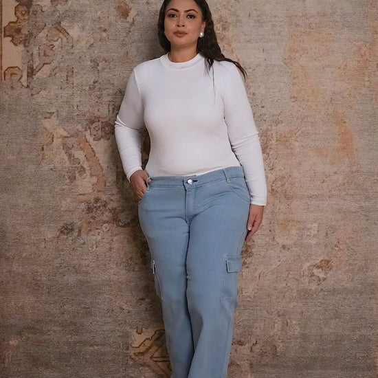 Plus size woman showcasing Curvisha utility buttoned denim pants with functional side pockets and premium stitching.