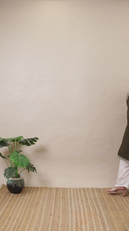 A plus-size model in a Curvisha dark olive green straight kurta with detailed silver embroidery on the yoke and sleeve cuffs.